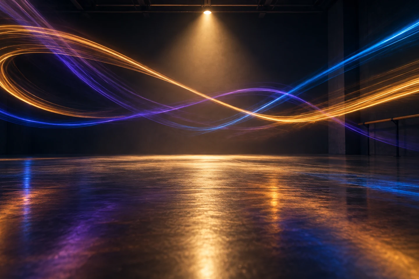 Long-exposure colored light trails crossing an empty dark studio floor.