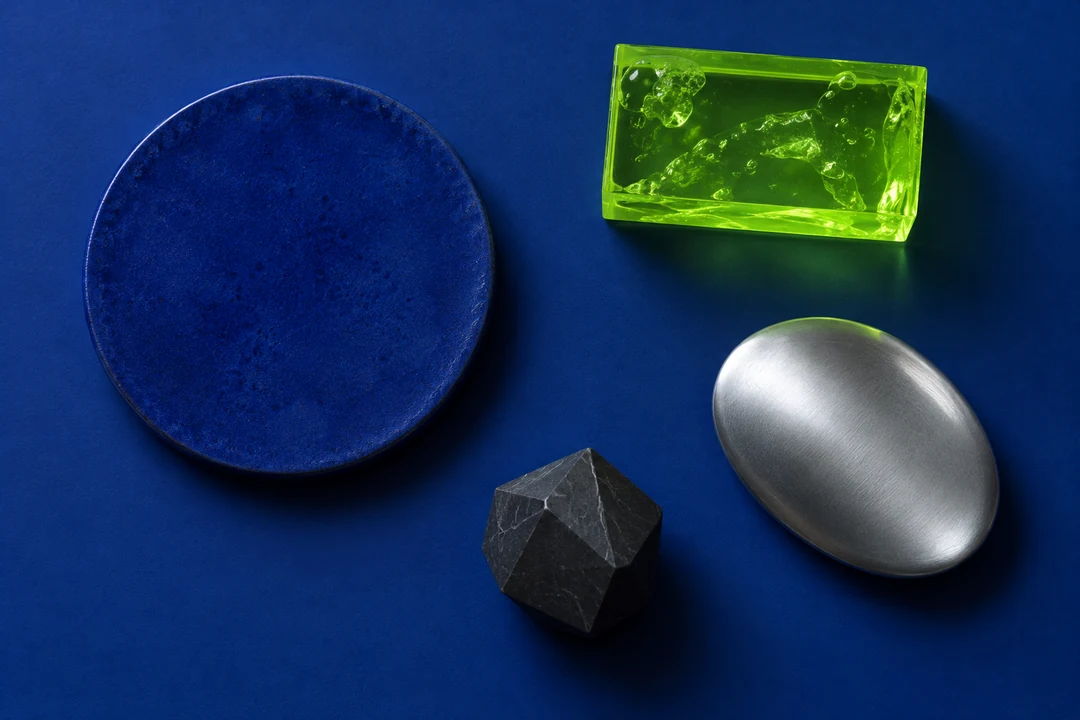 Overhead study of isolated cobalt, acid-green, and cool-silver material forms representing contrasting prepared-piano timbres